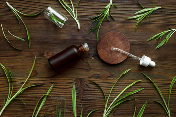 Herbal medicinal cosmetics - essential oil in a bottle with green leaves