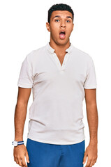 Young arab man wearing casual clothes in shock face, looking skeptical and sarcastic, surprised...