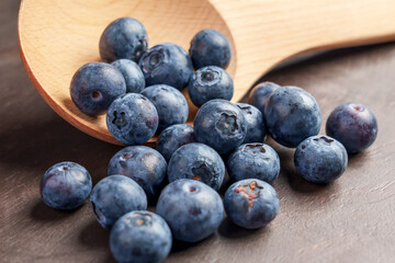 Fresh blueberries and wooden kitchenware