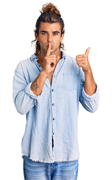 Young hispanic man wearing summer style asking to be quiet with finger on lips pointing with hand to the side. silence and secret concept.