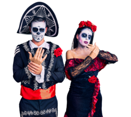 Young couple wearing mexican day of the dead costume over background suffering pain on hands and fingers, arthritis inflammation