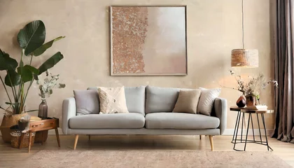 Poster Grey sofa near beige stucco wall and big poster frame on it. Boho, rustic interior design of living rom © Noor