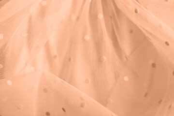 Peach fuzz, color of the year 2024, tulle fabric texture background, textile pattern, copy space