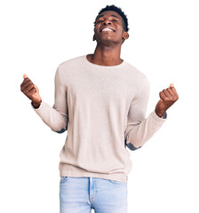 Young african american man wearing casual clothes very happy and excited doing winner gesture with arms raised, smiling and screaming for success. celebration concept.