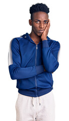 Fototapeta premium Young african american man wearing sportswear thinking looking tired and bored with depression problems with crossed arms.