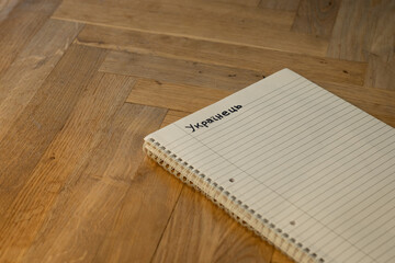 Fototapeta premium Blank notepad in class on wooden desk for student learning Ukrainian written language. communication subject for adult learning with handwritten notes and writing exercises for personal development