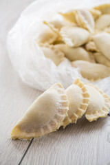 Fototapeta na wymiar Raw dumplings with filling inside, Ukrainian cuisine.
