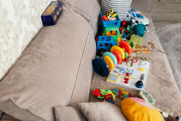 Different pile colorful toys balls on sofa in the living room decorated interior cozy atmosphere...