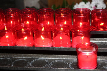 Candles light in dark church. Glowing and extinguished lights. Soul metaphor. Religious background....