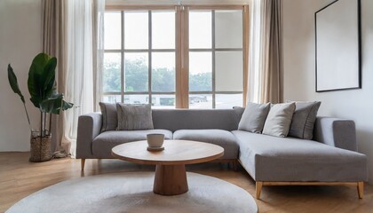 Grey chair and round coffee table near corner sofa against dark grey paneling wall. Scandinavian style home interior design of modern living room