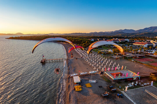 Aerial view of paramotors flying in formation at Calis Beach of Fethiye, Mugla, Turkey.