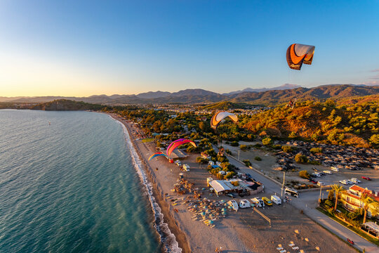 Aerial view of paramotors flying in formation at Calis Beach of Fethiye, Mugla, Turkey.