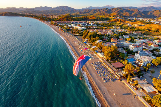 Aerial view of paramotors flying in formation at Calis Beach of Fethiye, Mugla, Turkey.
