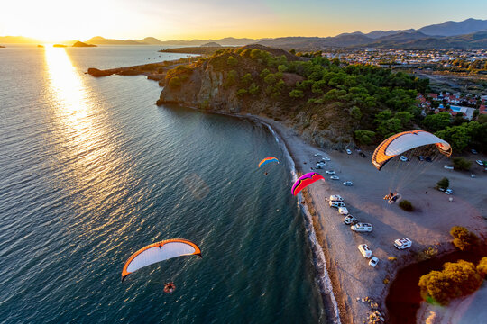 Aerial view of paramotors flying in formation at Calis Beach of Fethiye, Mugla, Turkey.