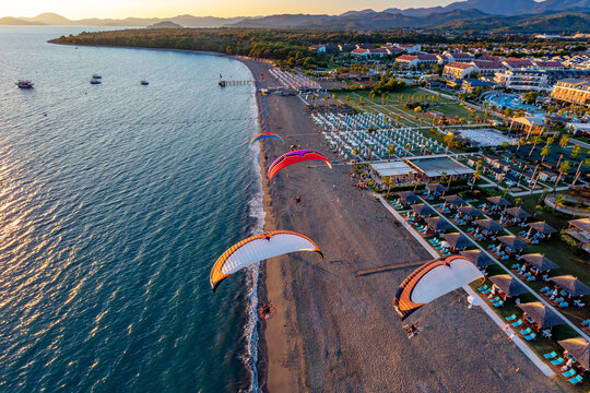 Aerial view of paramotors flying in formation at Calis Beach of Fethiye, Mugla, Turkey.