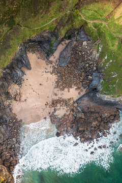 Aerial view of swimmer at secret cove, Talland Bay, Cornwall, United Kingdom.