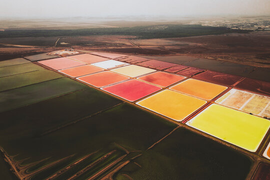 Aerial view of colourful Salinas, salt lakes pool at Farm colony la Algaida, Andalusia, Spain.
