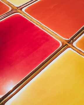 Aerial view of colourful Salinas, salt lakes pool at Farm colony la Algaida, Andalusia, Spain.