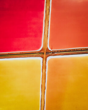 Aerial view of colourful Salinas, salt lakes pool at Farm colony la Algaida, Andalusia, Spain.