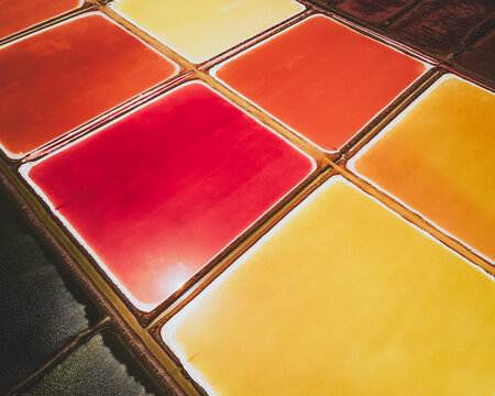Aerial view of colourful Salinas, salt lakes pool at Farm colony la Algaida, Andalusia, Spain.