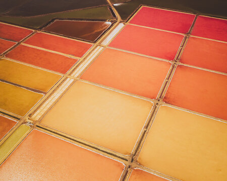 Aerial view of colourful Salinas, salt lakes pool at Farm colony la Algaida, Andalusia, Spain.
