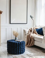 Navy blue ottoman near white sofa with beige blanket against window and white wall with big frame poster. Scandinavian home interior design of modern living room
