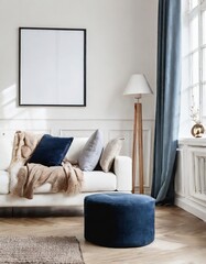 Navy blue ottoman near white sofa with beige blanket against window and white wall with big frame poster. Scandinavian home interior design of modern living room