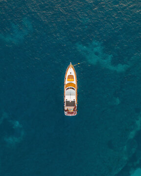 Aerial topdown shot of a yacht in the Mediterranean Sea, Mallorca, Baleares, Spain.