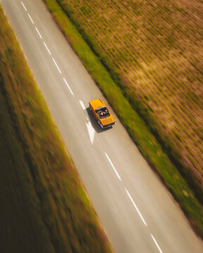 Aerial view of a Yellow English convertible Car, Haute Vall&eacute;e de Chevreuse Park, Ile de France, France.