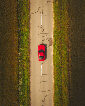 Aerial view of a Red Sport Japanese Car, Haute Vall&eacute;e de Chevreuse Park, Ile de France, France.