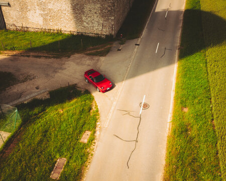 Aerial view of a Red Sport Japanese Car, Haute Vall&eacute;e de Chevreuse Park, Ile de France, France.