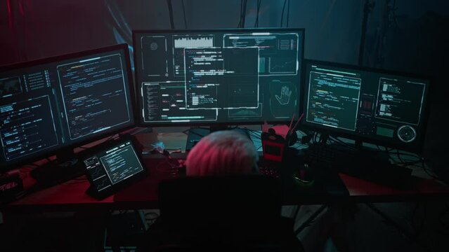 Coder processes data overseeing various computer displays