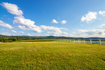 field and blue sky with clouds