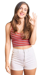 Fototapeta premium Beautiful caucasian young woman wearing casual clothes smiling positive doing ok sign with hand and fingers. successful expression.