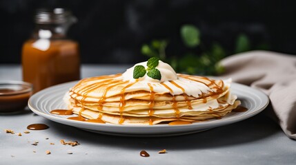 The thought of having a delectable breakfast consisting of crepes filled with peanut butter and milk on a gray table. - obrazy, fototapety, plakaty