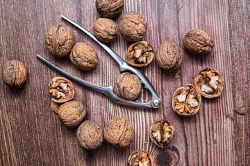 Fototapeta na wymiar nutcracker next to walnuts. Cracking nuts before Christmas