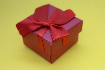 A red bow on a yellow surface