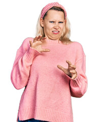 Young caucasian woman wearing casual clothes disgusted expression, displeased and fearful doing disgust face because aversion reaction. with hands raised