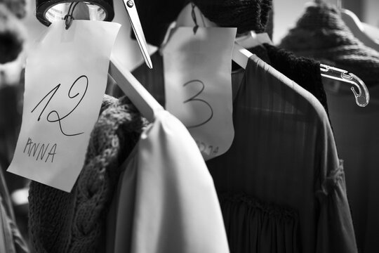 Backstage of a fashion show, clothes hanging in the wardrobe