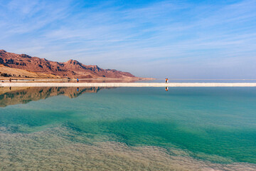 Fototapeta na wymiar The Dead Sea is a salt lake between Israel, Jordan and the West Bank, which is the lowest landmass on Earth. The Dead Sea is one of the saltiest bodies of water on Earth.