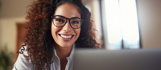 Close up photo of young beautiful business woman with curly hair and glasses Hispanic woman talking on video call using laptop for remote communication and conference. Copyspace image. Square banner