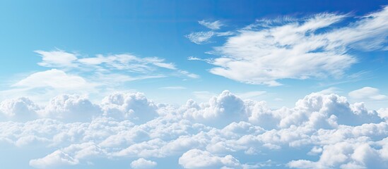An awe inspiring photograph capturing the beauty of a clear blue sky adorned with fluffy clouds during the daytime A serene and picturesque image showcasing the wonders of nature s canvas