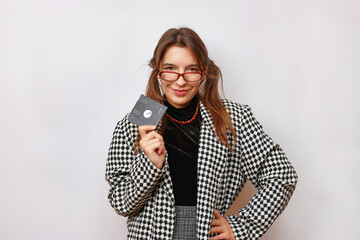 A beautiful, smiling girl in glasses holds an FDD in her hand.