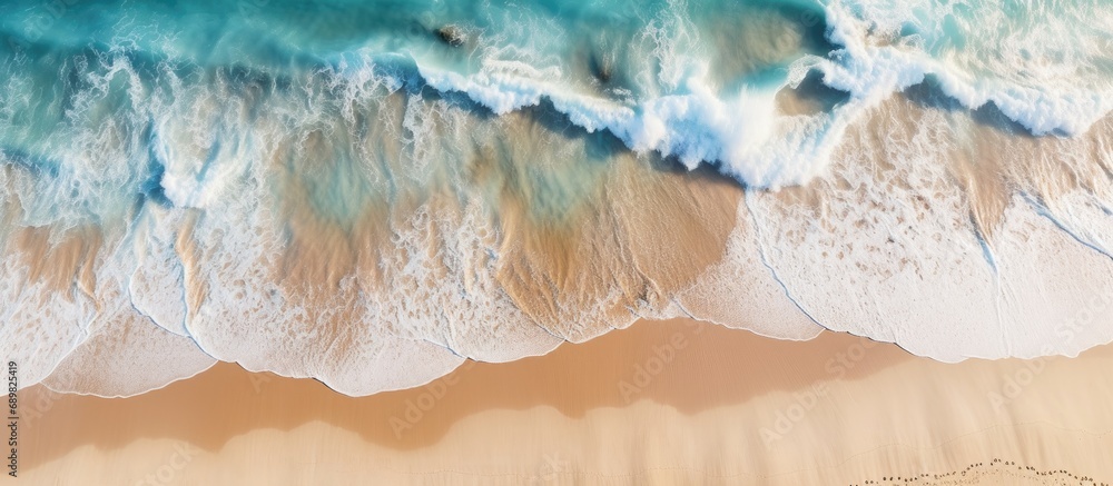 Poster aerial view of ocean waves washing a secluded sandy shoreline beach. copyspace image. square banner.