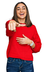 Beautiful brunette woman wearing casual winter sweater laughing at you, pointing finger to the camera with hand over body, shame expression