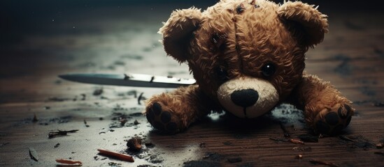 adorable teddy bear lying on the floor destroyed with a knife. Copyspace image. Square banner. Header for website template - obrazy, fototapety, plakaty