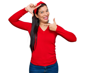 Young hispanic woman wearing casual clothes smiling making frame with hands and fingers with happy face. creativity and photography concept.