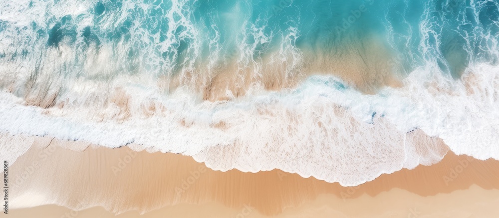 Poster aerial view of ocean waves washing a secluded sandy shoreline beach. copyspace image. square banner.