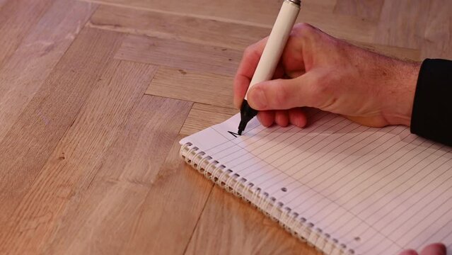 Blank notepad in class on wooden desk for student learning Dutch written language. Nederlands subject for adult learning with handwritten notes and writing exercises for personal development