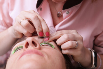 Eyelash care procedures. Lamination of eyelashes. Eyelash extension for a girl in a beauty salon. The concept of beauty.